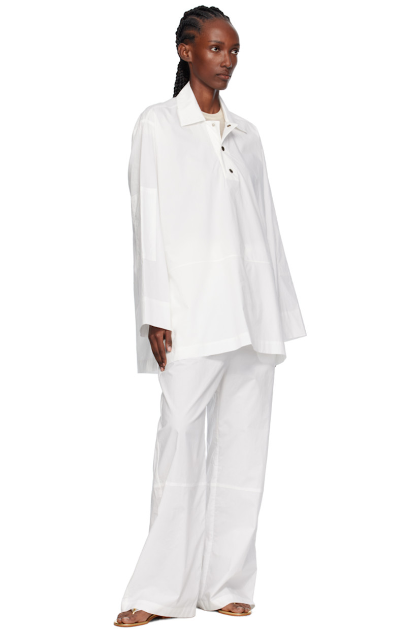 Cotton poplin overshirt.

· Stand collar
· Press-stud placket
· Dropped shoulders

Supplier color: White