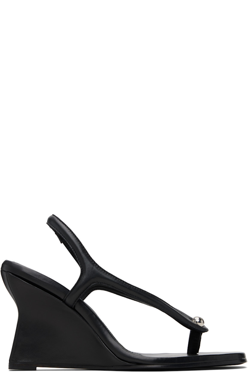 Buffed leather heeled sandals.

· Square toe
· Thong-style strap with stud at vamp
· Partially elasticized slingback strap
· Logo embossed at padded footbed
· Covered wedge heel with rubber injection
· Leather sole
· Heel: H3.5"

Supplier color: Black