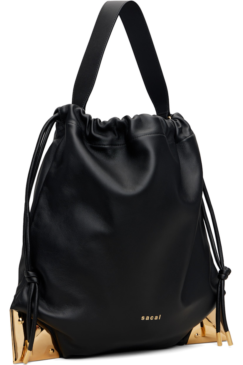 Grained lambskin shoulder bag. 

· Fixed shoulder strap
· Logo stamp at face
· Gold-tone plaques at corners
· Drawstring closure
· Felted lining 
· H14.5" x W15" x D0.5"

Supplier color: Black