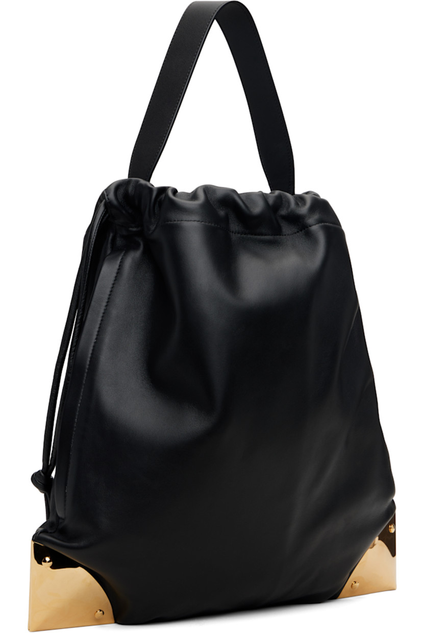 Grained lambskin shoulder bag. 

· Fixed shoulder strap
· Logo stamp at face
· Gold-tone plaques at corners
· Drawstring closure
· Felted lining 
· H14.5" x W15" x D0.5"

Supplier color: Black