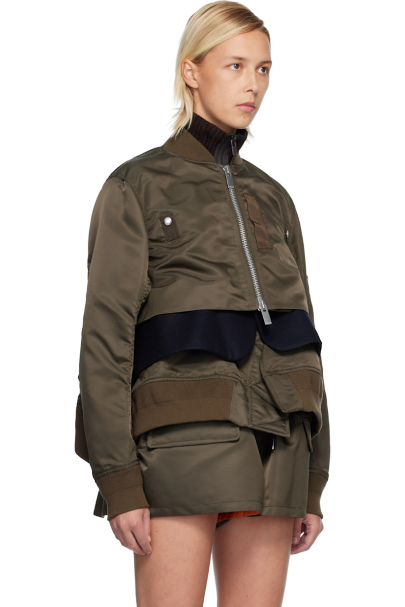 Nylon satin bomber jacket.

· Paneled construction 
· Rib-knit stand collar, hem, and cuffs
· Two-way zip closure
· Press-stud tabs at chest
· Melton panel at waist 
· Cropped asymmetric hem 
· Vented side seams 
· Utility pocket and pen slots at sleeve
· Full satin lining 

Supplier color: D/Khaki