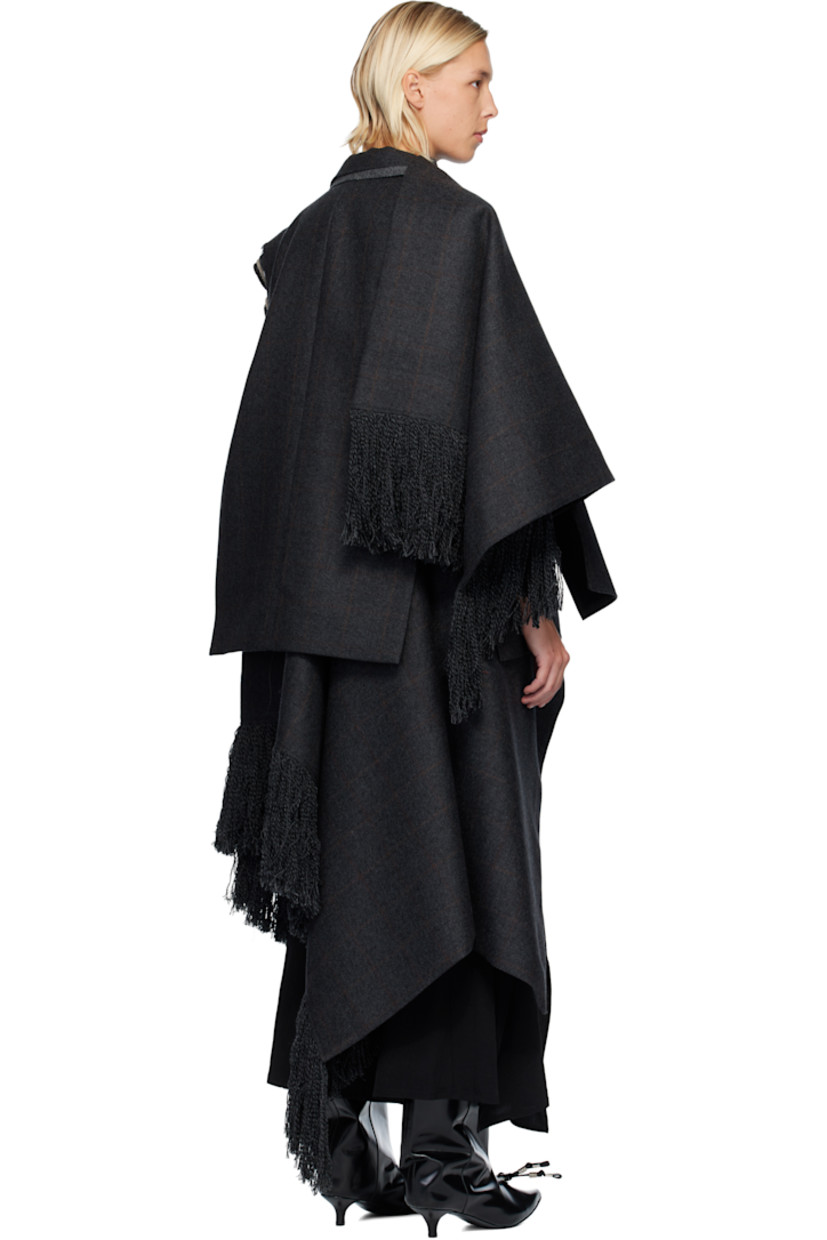 Double-faced wool melton vest. 

· Layered construction 
· Raw edges and check pattern throughout 
· Peaked lapels
· Double-breasted button closure
· Welt pocket at chest
· Flap pockets at waist
· Press-stud tabs at side seam
· Fringed detailing at asymmetric hem 

Supplier color: Gray