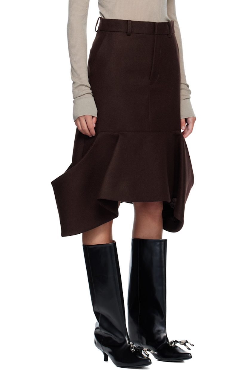 Wool melton midi skirt. 

· Belt loops
· Four-pocket styling
· Zip fly 
· Patch pockets at draped hem 

Supplier color: Brown