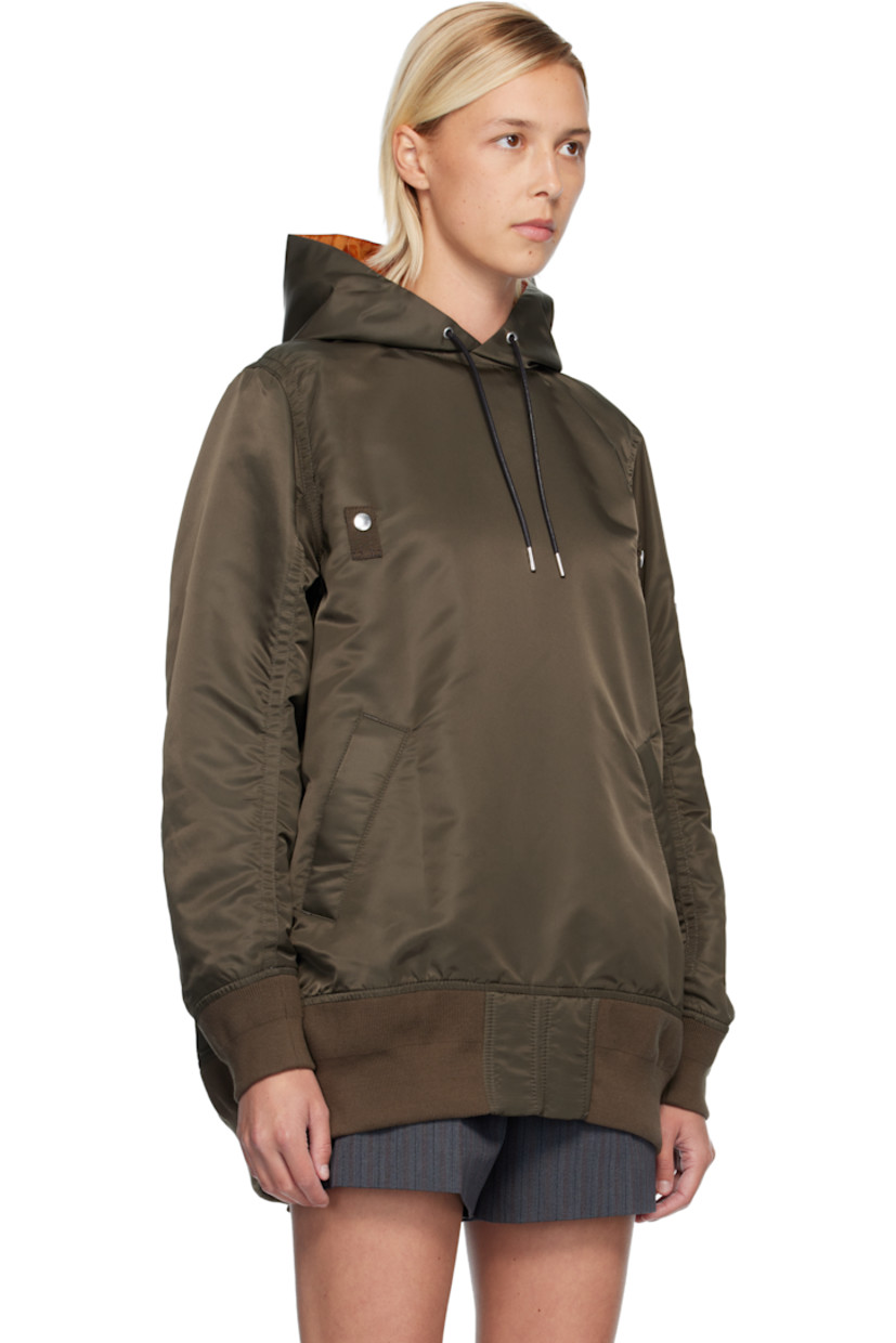 Nylon twill hoodie.

· Drawstring at hood 
· Press-stud tabs at chest
· Welt pockets at waist
· Rib-knit hem and cuffs
· Utility pocket and pen slots at sleeve
· Zip vent at back 
· Full satin lining 

Supplier color: D/Khaki