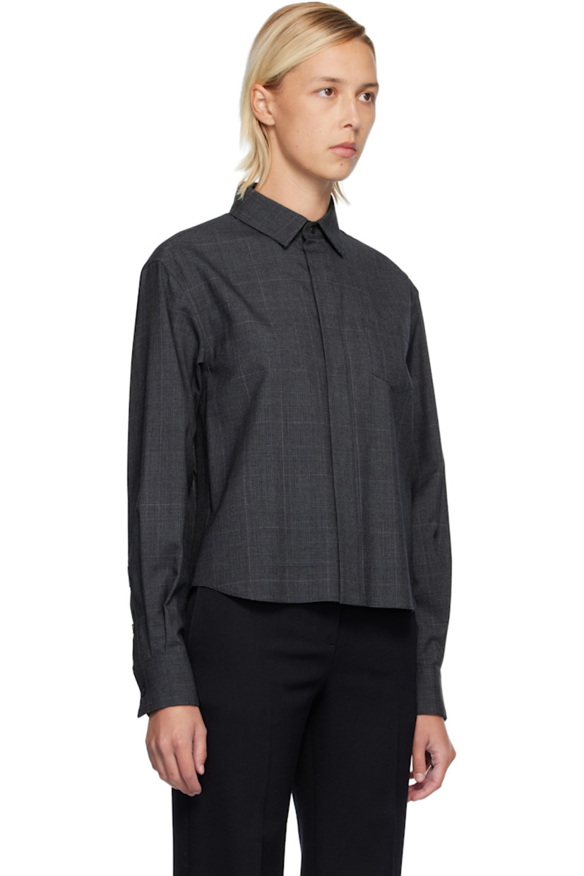 Plain-woven wool shirt. 

· Houndstooth pattern throughout 
· Spread collar 
· Button closure 
· Patch pocket at chest
· Pleats at buttoned barrel cuffs
· Pleats at chiffon back yoke 

Supplier color: Gray