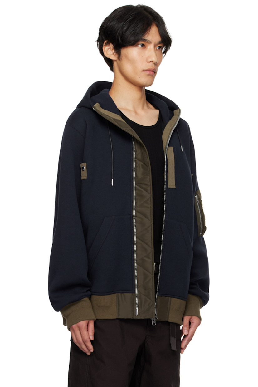 Cotton-blend jersey hoodie.

· Drawstring at hood
· Funnel neck
· Two-way zip closure
· Press-stud tabs at chest
· Patch pockets
· Rib-knit hem and cuffs
· Utility pocket at sleeve

Supplier color: Navy/D khaki