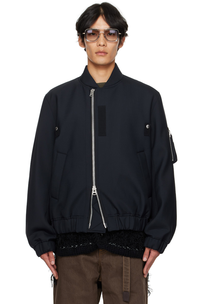 Insulated plain-woven wool-blend bomber jacket.

· Stand collar
· Offset two-way zip closure
· Press-stud tabs at chest
· Welt pockets at front
· Elasticized hem and cuffs
· Utility pocket at sleeve
· Full cupro satin lining

Supplier color: Navy
