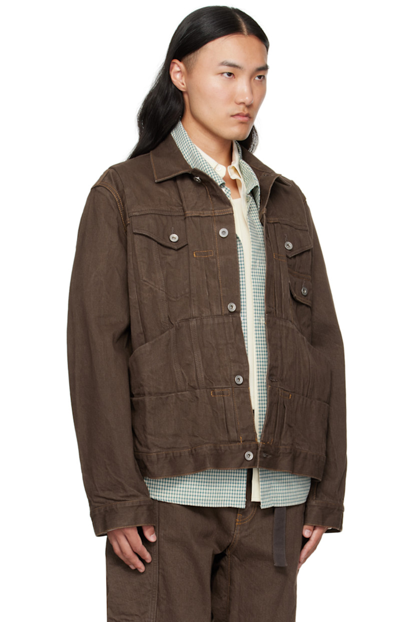 Crinkled non-stretch denim jacket.

· Pintucks throughout 
· Spread collar 
· Button closure
· Flap pockets at chest
· Patch pockets at waist
· Button tab at cuffs
· Paneled back yoke 
· Cinch tab at back 
· Contrast stitching in tan

Supplier color: Brown