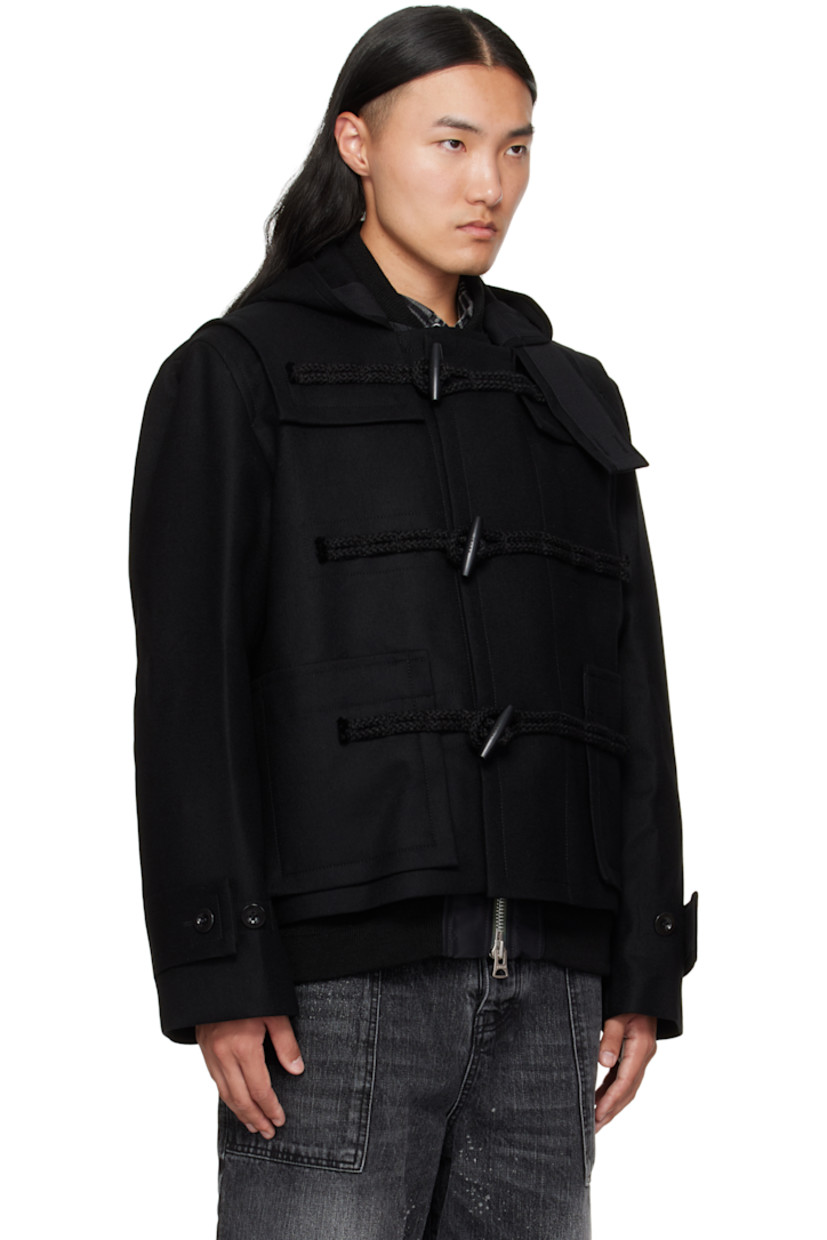 Wool melton and nylon twill bomber jacket.

· Layered and paneled construction 
· Throat guard and studs at hood
· Rib-knit stand collar, hem, and cuffs
· Toggle closure 
· Concealed two-way zip closure 
· Patch pockets and concealed welt pockets at waist 
· Press-stud vents at side seams 
· Button tabs at cuffs
· Inset rib-knit cuffs
· Fully lined

Supplier color: Black
