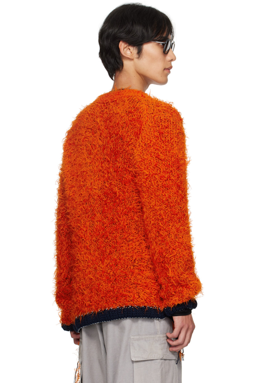 Shag-knit cardigan. 

· Rib-knit Y-neck, hem, and cuffs
· Button closure
· Welt pockets at front 
· Loose thread detailing at side seams and cuffs
· Contrast stitching in white 

Supplier color: Orange
