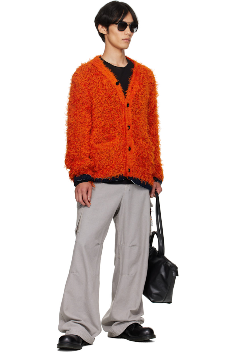 Shag-knit cardigan. 

· Rib-knit Y-neck, hem, and cuffs
· Button closure
· Welt pockets at front 
· Loose thread detailing at side seams and cuffs
· Contrast stitching in white 

Supplier color: Orange