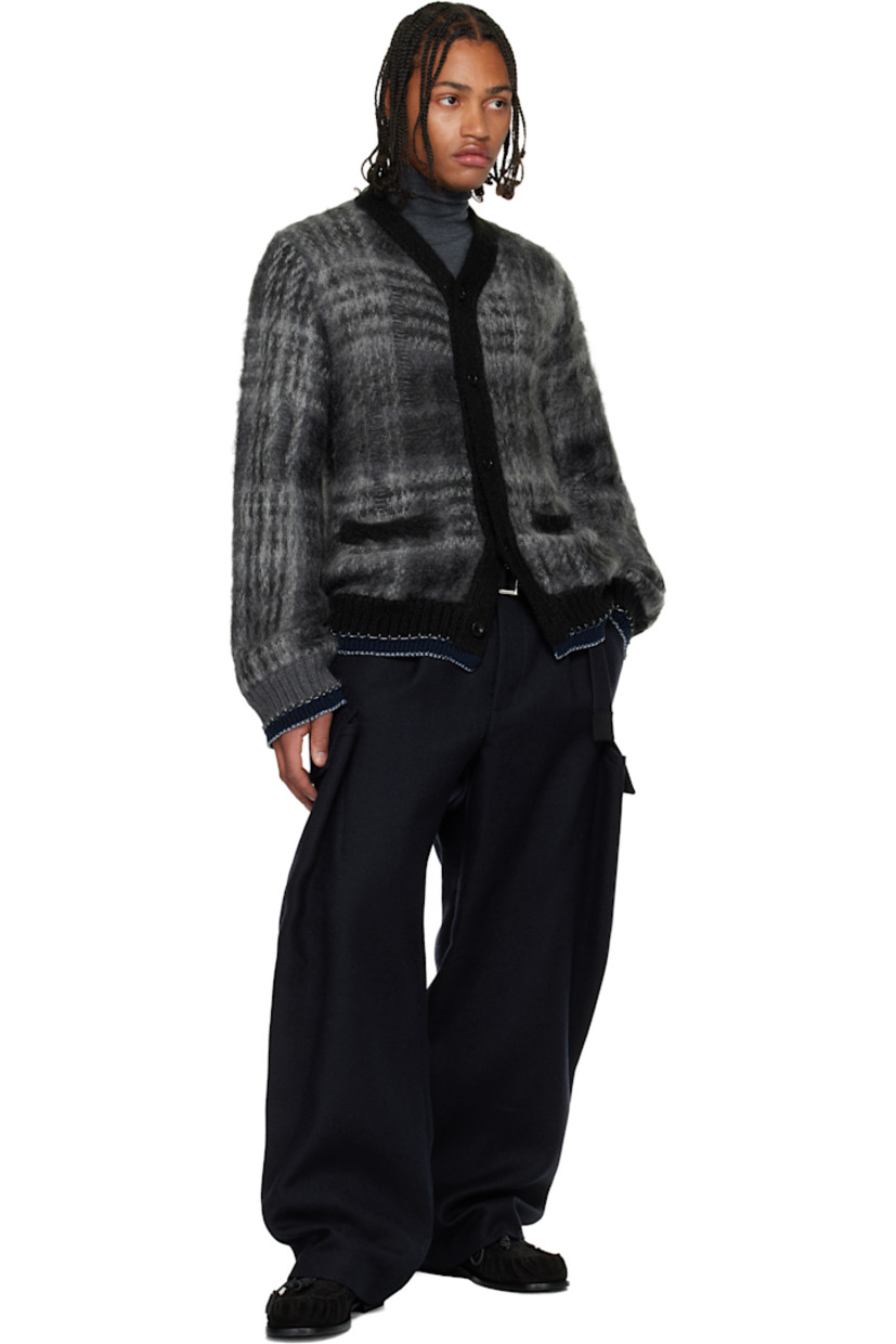 Brushed knit mohair-blend cardigan.

· Check pattern and distressing throughout
· Rib-knit Y-neck, hem, and cuffs
· Button closure
· Welt pockets at front
· Blanket stitching at hem and cuffs

Supplier color: Black