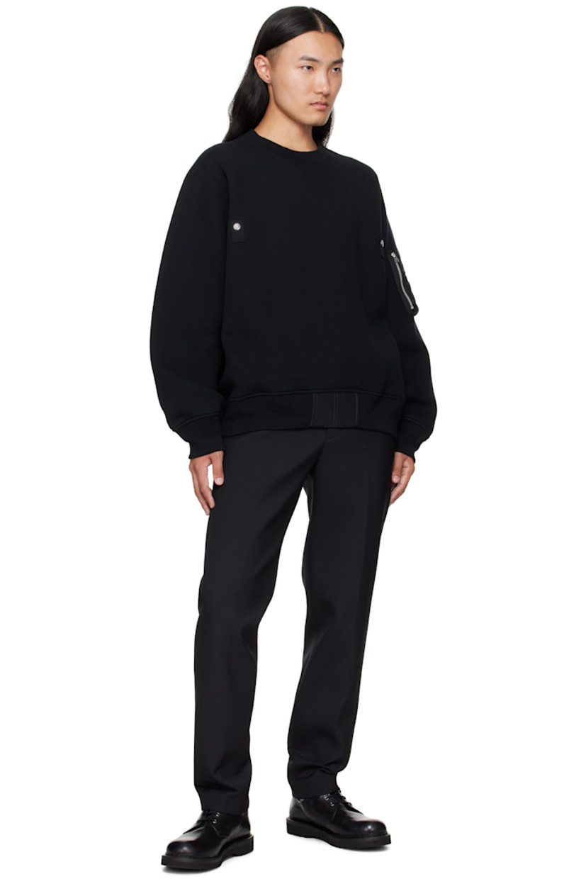 Double-faced cotton-blend fleece sweater. 

· Rib-knit crewneck, hem, and cuffs 
· Logo-engraved press-stud tab at chest
· Nylon twill trim at front hem 
· Dropped shoulders
· Utility pocket and pen slots at sleeve

Supplier color: Black