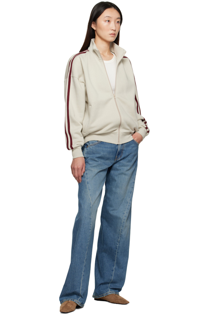 Non-stretch denim jeans.

· Fading and whiskering throughout
· Wide-leg
· Mid-rise
· Belt loops
· Five-pocket styling
· Zip fly
· Twisted inseams and outseams
· Subtle distressing at cuffs
· Adjustable cinch tab at back waistband
· Logo patch at back waistband
· Contrast stitching in beige

Supplier color: Soft mid blue