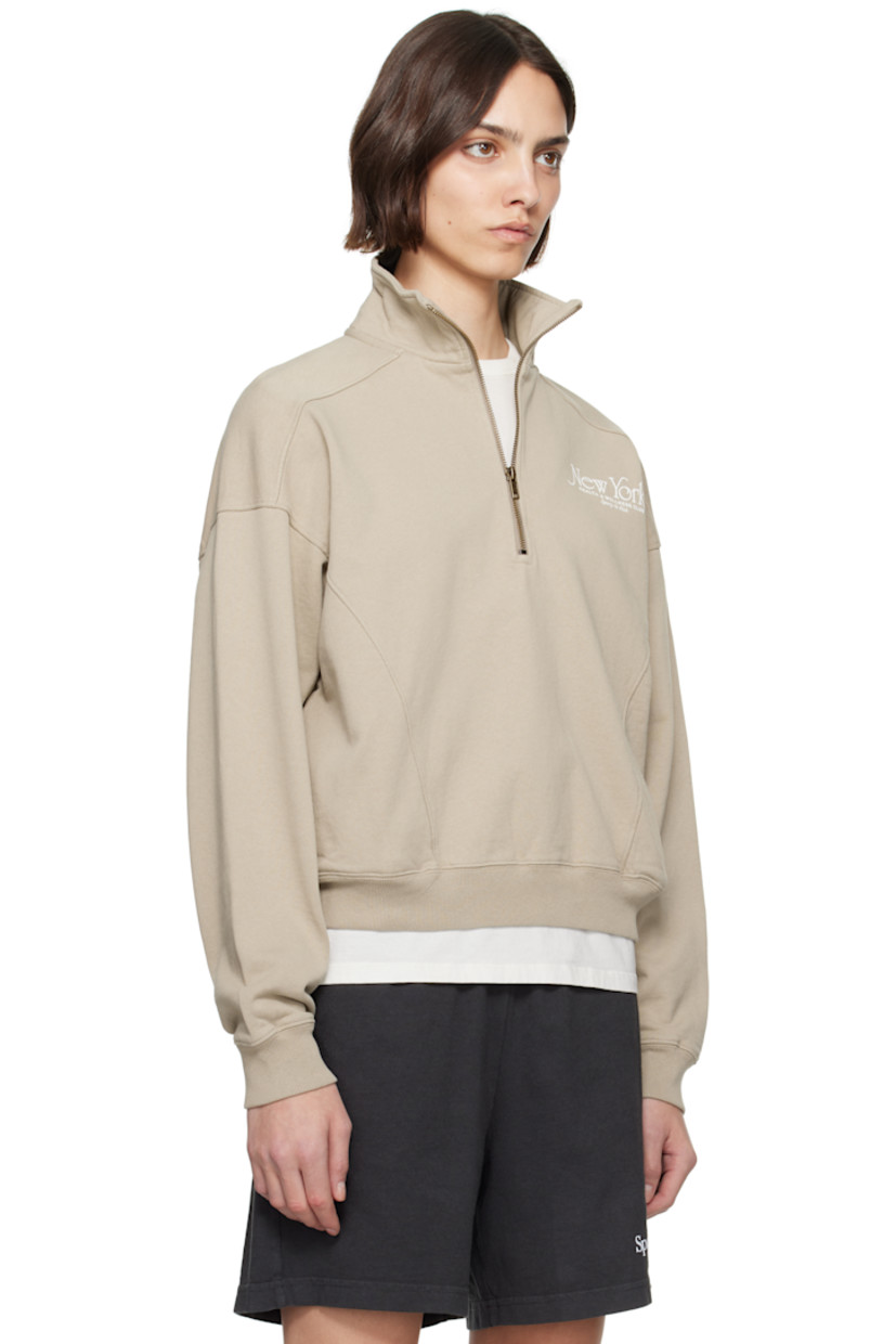 Cotton fleece sweatshirt.

· Pre-shrunk
· Stand collar
· Half-zip closure
· Logo printed at chest
· Seam pockets
· Rib-knit hem and cuffs
· Saddle shoulders

Supplier color: Elephant/White