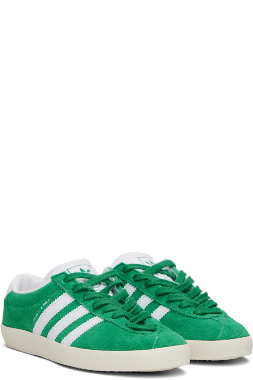 Low-top suede and buffed leather sneakers. 

· Serrated edges throughout
· Lace-up closure
· Logo printed at tongue
· Padded collar
· Signature stripes at sides
· Logo stamp at outer side
· Treaded rubber sole

Part of the Sporty & Rich x adidas Originals collaboration.

Supplier color: Court green/Cloud white/Off white