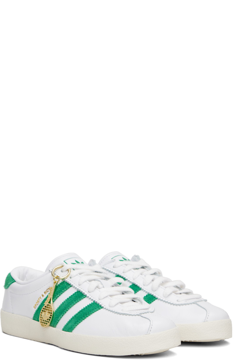 Low-top buffed leather and suede sneakers. 

· Serrated edges throughout
· Lace-up closure
· Logo printed at tongue
· Padded collar
· Signature stripes at sides
· Logo stamp at outer side
· Treaded rubber sole

Part of the Sporty & Rich x adidas Originals collaboration.

Supplier color: Cloud white/Off white/Court green
