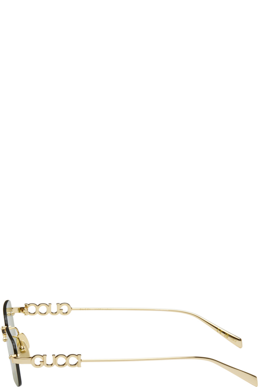 Rectangular rimless metal-frame sunglasses in gold tone.

· Iridescent logo pattern at green lenses
· 100% UVA/UVB protection, category 2
· Logo etched at lens
· Adjustable metal nose pads
· Logo hardware at temples
· Includes pouch
· Size: 52.20 145

Supplier color: Gold