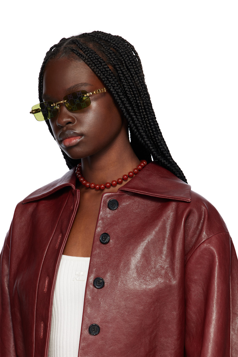 Rectangular rimless metal-frame sunglasses in gold tone.

· Iridescent logo pattern at green lenses
· 100% UVA/UVB protection, category 2
· Logo etched at lens
· Adjustable metal nose pads
· Logo hardware at temples
· Includes pouch
· Size: 52.20 145

Supplier color: Gold