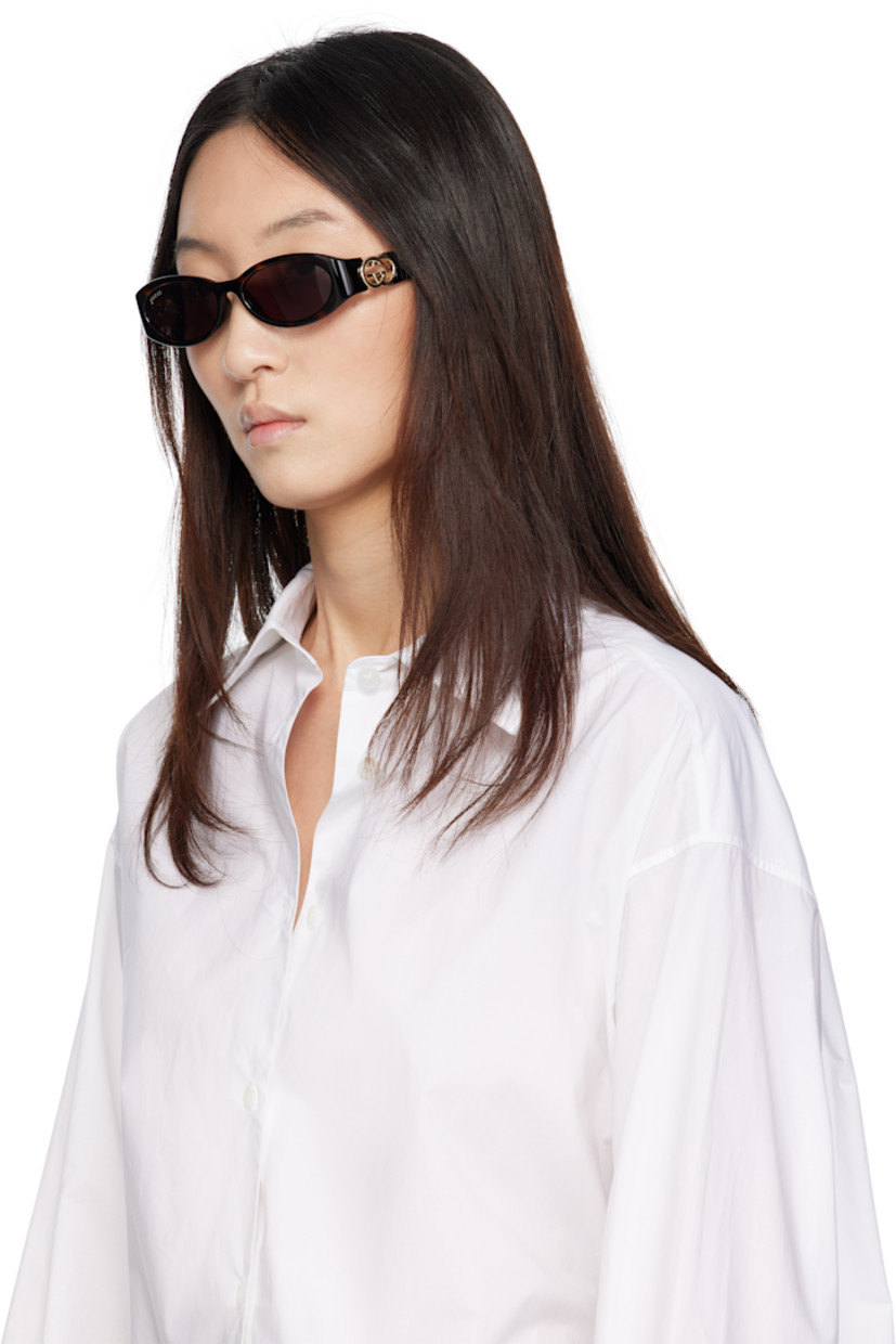 Oval tortoiseshell acetate-frame sunglasses in brown.

· Brown lenses, category 3
· 100% UVA/UVB protection
· Logo etched at lens
· Integrated nose pads
· Logo hardware and cutout at temples
· Includes case
· Size: 54.16 135

Supplier color: Tortoiseshell