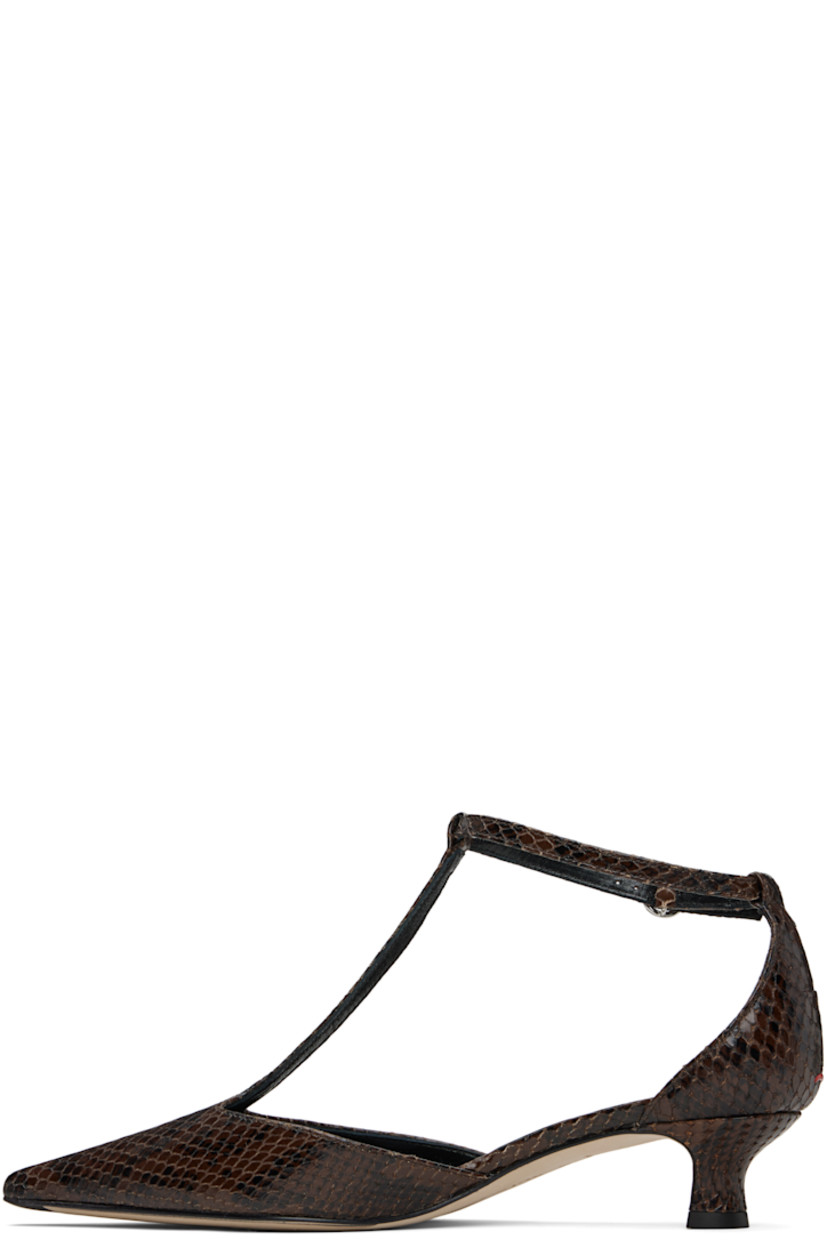 Snakeskin-embossed calfskin heels.

· Pointed toe 
· Strap at vamp
· Pin-buckle ankle strap
· Red stitch at heel counter
· Lambskin lining 
· Covered kitten heel 
· Nubuck sole with rubber injections 
· Heel: H1.5"

Supplier color: Moka