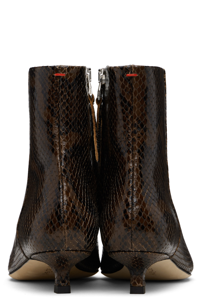 Ankle-high snake-embossed calfskin boots.

· Pointed toe
· Zip closure at inner side
· Red stitch at heel collar
· Buffed lambskin lining
· Covered kitten heel
· Leather sole with rubber injections
· Heel: H1"

Supplier color: Moka