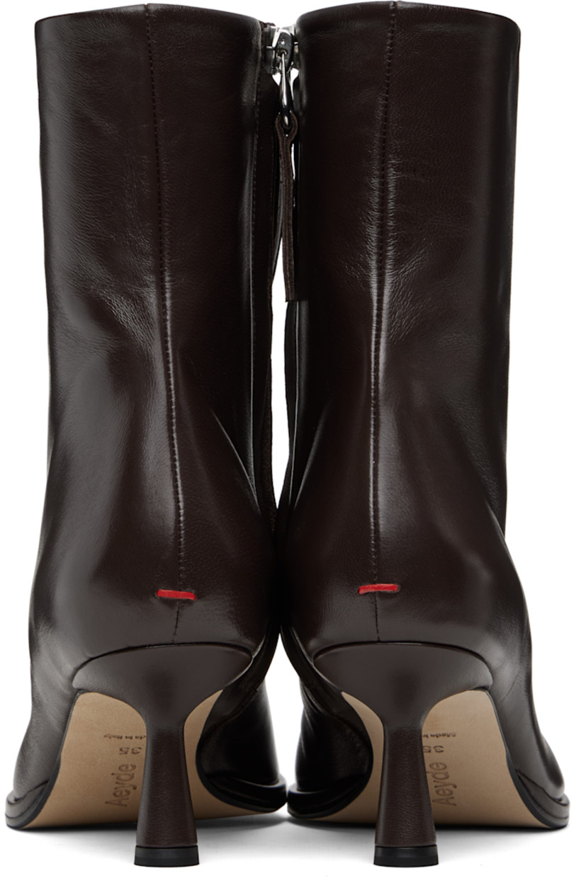 Ankle-high buffed nappa leather boots.

· Zip closure at inner side
· Lambskin lining 
· Red stitch at heel counter
· Covered spool heel 
· Nubuck sole with rubber injections
· Heel: H2.5"

Supplier color: Moka nappa