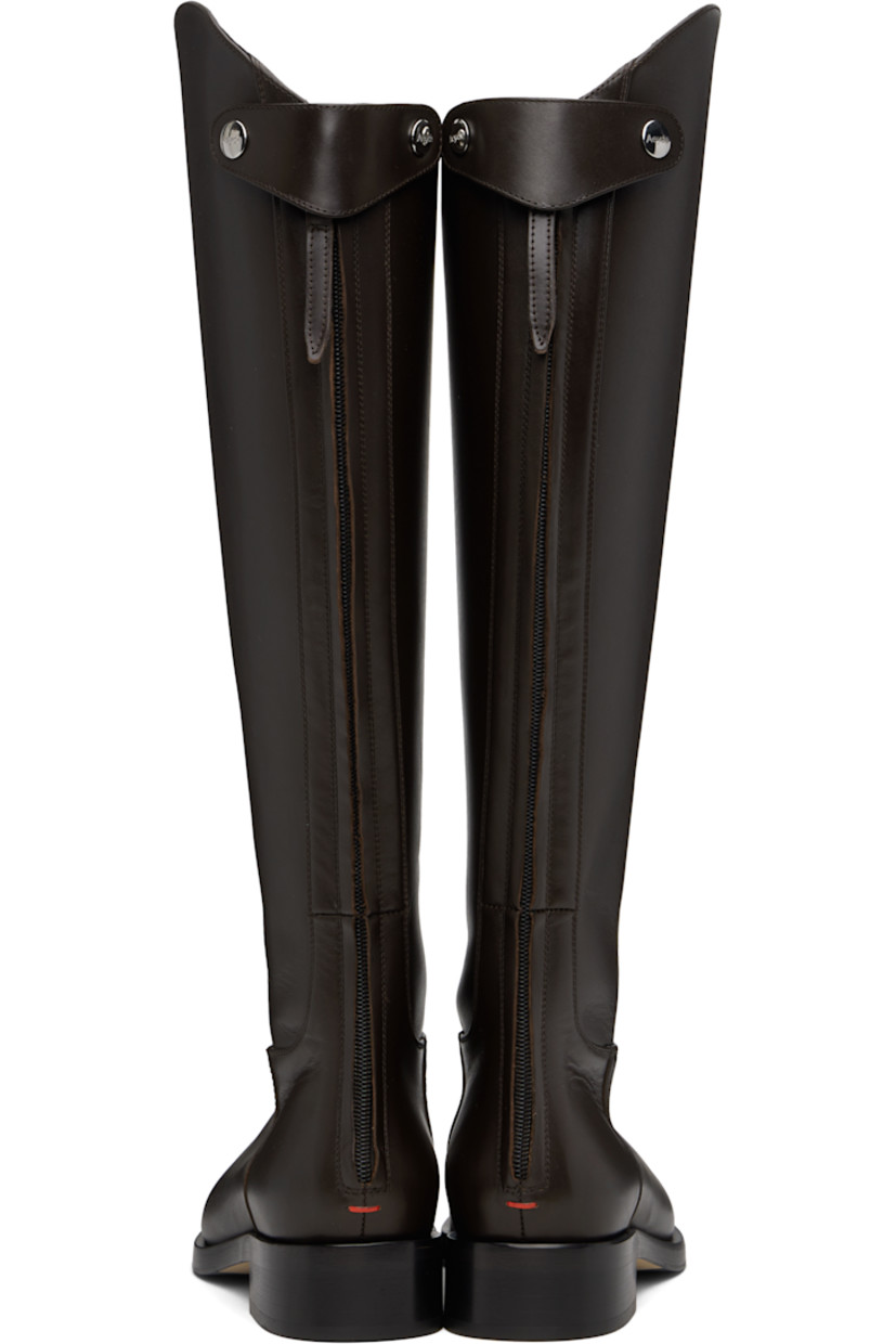 Knee-high buffed calfskin boots.

· Press-stud tab and zip closure at heel
· Red stitch at heel counter
· Buffed leather lining
· Stacked leather midsole and block heel
· Smooth rubber sole
· Logo-engraved silver-tone hardware
· Heel: H1.25"

Supplier color: Moka