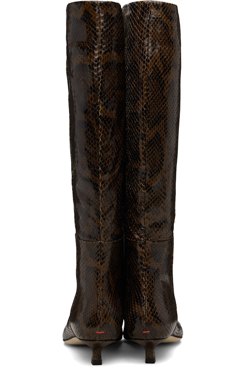 Knee-high snake-embossed calfskin boots.

· Paneled construction
· Pointed toe
· Zip closure at inner side
· Red stitch at heel
· Buffed leather lining
· Kitten heel
· Leather sole with rubber injections
· Heel: H1.25"

Supplier color: Moka