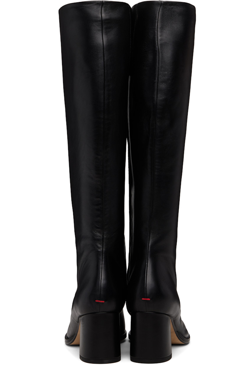 Knee-high grained nappa leather boots.

· Central seam at vamp
· Concealed elasticized gusset at collar
· Zip closure at inner side
· Red stitch at heel
· Buffed leather lining
· Block heel with rubber injection
· Leather sole
· Heel: H2.5"

Supplier color: Black