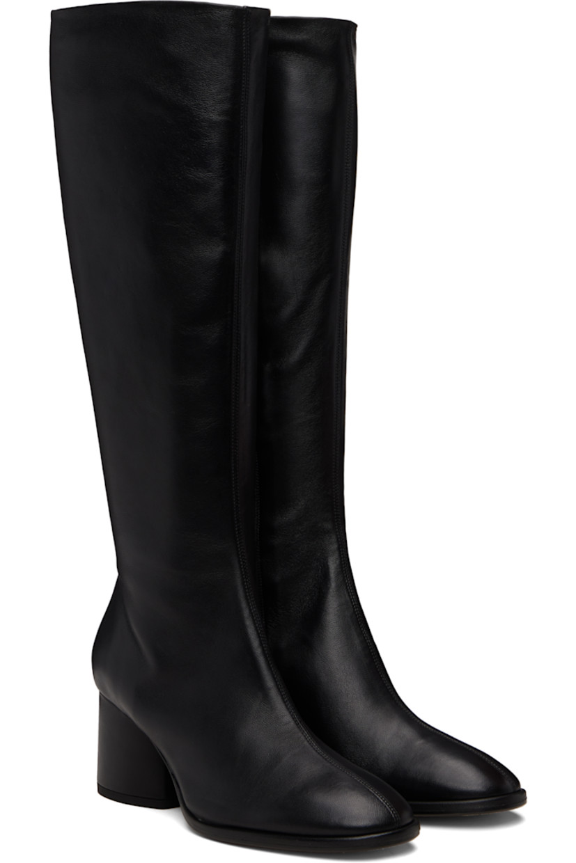 Knee-high grained nappa leather boots.

· Central seam at vamp
· Concealed elasticized gusset at collar
· Zip closure at inner side
· Red stitch at heel
· Buffed leather lining
· Block heel with rubber injection
· Leather sole
· Heel: H2.5"

Supplier color: Black