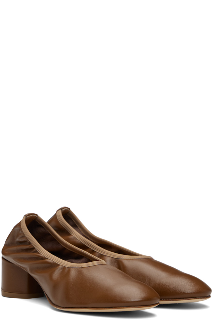 Grained nappa leather ballerina-style heels.

· Elasticized collar
· Red stitch at heel tab
· Suede interior
· Covered block heel with rubber injection
· Nubuck sole
· Heel: H2"

Supplier color: Tobacco