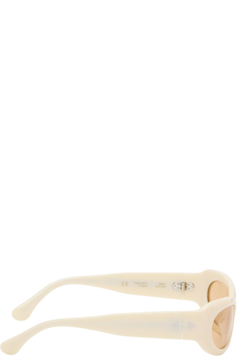 Handcrafted oval cat-eye semi-transparent acetate-frame sunglasses in beige. 

· Orange lenses
· 100% UVA/UVB protection 
· Integrated nose pads
· Rivets at temples
· Semi-exposed core wires 
· Includes pouch
· Size: 53.21 135

Part of the exclusive SSENSE HEAT capsule.

Supplier color: Ivory/Amber