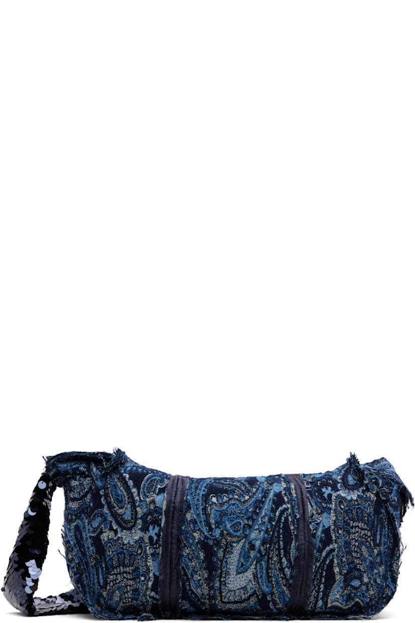 Paneled gobelin shoulder bag.

· Jacquard paisley pattern throughout
· Exposed seams and raw edges throughout
· Fixed sequinned crossbody strap
· Zip closure
· Patch pocket at interior
· Satin lining
· H8" x W14.5" x D5"

Supplier color: Blue/Navy