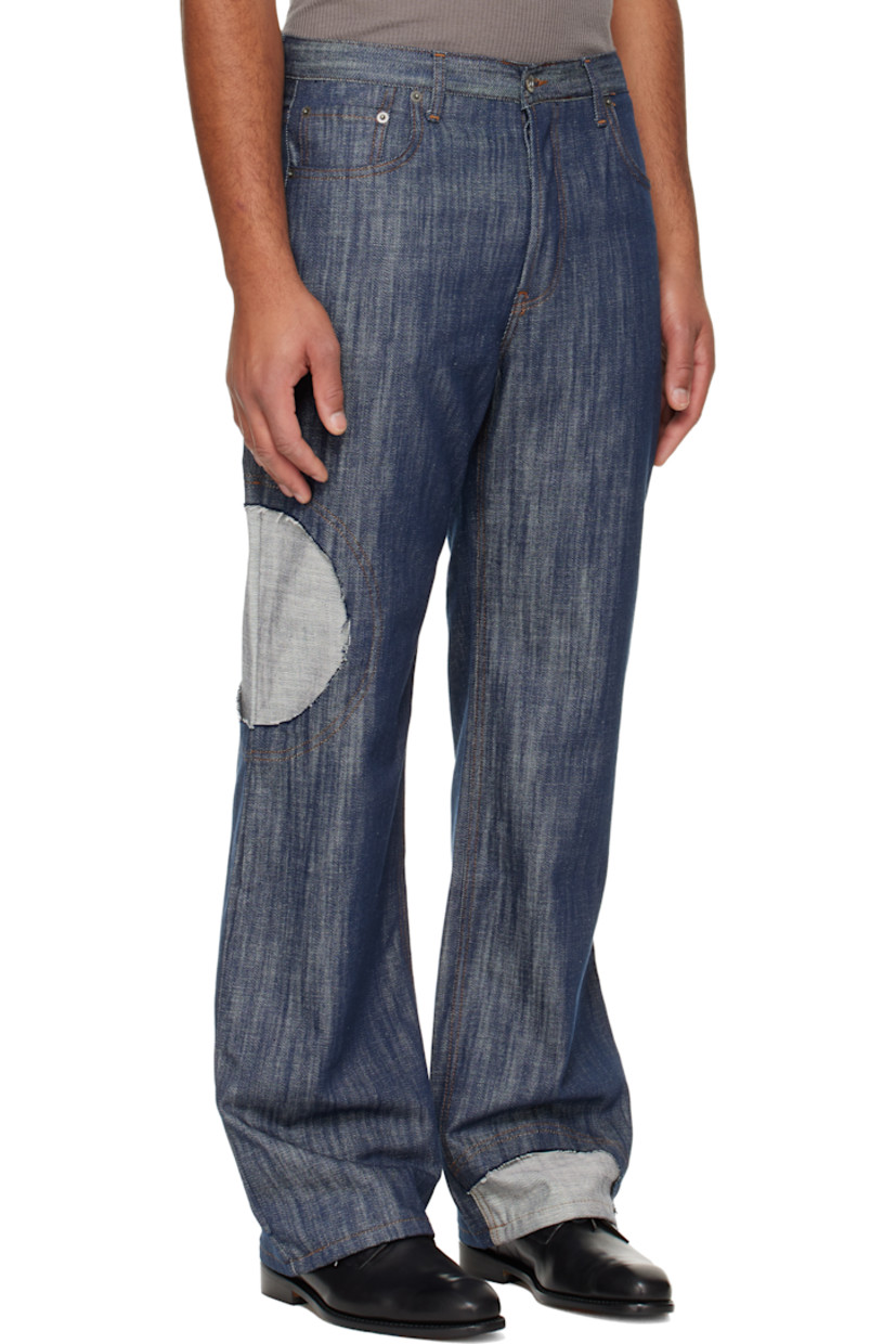 Lightweight non-stretch denim jeans. 

· Straight-leg
· Belt loops
· Five-pocket styling
· Button-fly
· Inset panel with raw edge at leg
· Logo patch at back waistband
· Contrast stitching in tan

Supplier color: Indigo