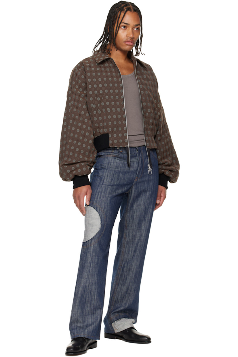 Lightweight non-stretch denim jeans. 

· Straight-leg
· Belt loops
· Five-pocket styling
· Button-fly
· Inset panel with raw edge at leg
· Logo patch at back waistband
· Contrast stitching in tan

Supplier color: Indigo