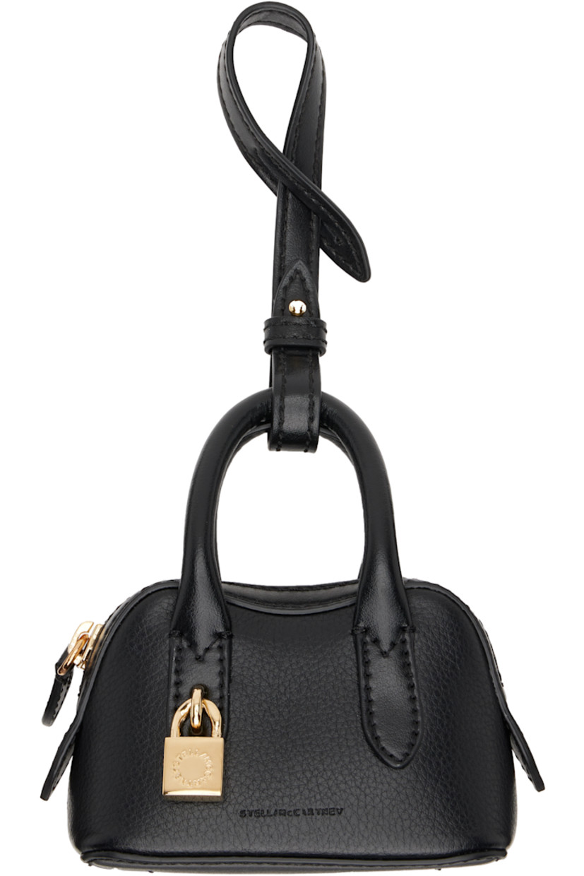 Pebble-grained faux-leather keychain in black.

· Logo stamp and graphic charm at face
· Zip pocket
· Lanyard with post-stud fastening 
· Gold-tone hardware
· H9" x W4.25" x D2.5"

Made from cruelty-free, non-animal materials.

Supplier color: Black