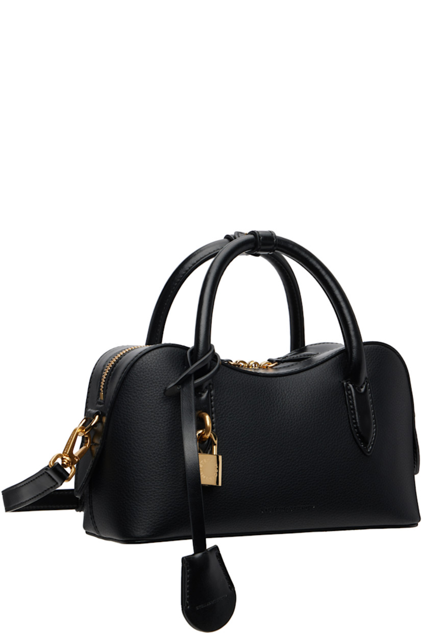 Grained faux-leather top handle bag.

· Press-stud tab at rolled carry handles
· Detachable logo-embossed sheathed key at handle
· Adjustable and detachable crossbody strap
· Padlock and embossed logo at face
· Bumper studs at base
· Two-way zip closure
· Patch pocket at interior
· GOTS-certified organic hemp-blend canvas lining
· Logo-engraved antiqued gold-tone hardware
· H5" x W9.25" x D3.5"

Made from cruelty-free, non-animal materials.

Supplier color: Black