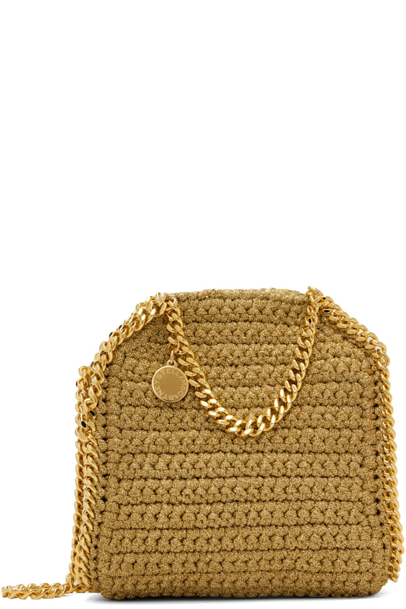 Crocheted lurex cord shoulder bag. 

· Curb chain trim throughout
· Curb chain carry handles and shoulder strap
· Logo disc at strap base
· Magnetic press-stud closure
· Patch pocket at interior
· Unlined
· H7" x W6" x D2.5" 

Made from cruelty-free, non-animal materials.

Supplier color: Gold