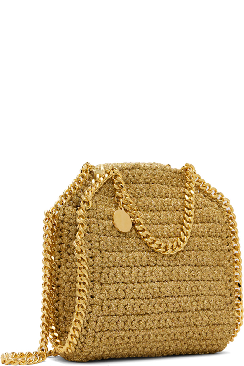 Crocheted lurex cord shoulder bag. 

· Curb chain trim throughout
· Curb chain carry handles and shoulder strap
· Logo disc at strap base
· Magnetic press-stud closure
· Patch pocket at interior
· Unlined
· H7" x W6" x D2.5" 

Made from cruelty-free, non-animal materials.

Supplier color: Gold
