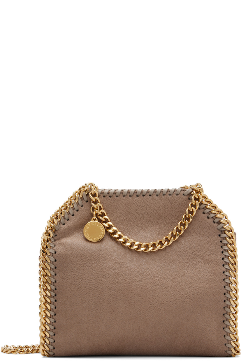 Faux-suede shoulder bag. 

· Whipstitching and chain trim throughout
· Curb chain carry handles and shoulder strap
· Logo disc at strap base
· Magnetic press-stud closure
· Patch pocket at interior
· Logo-patterned textile lining
· Gold-tone hardware
· H7" x W6" x D2.5" 

Made from cruelty-free, non-animal materials.

Supplier color: Moss