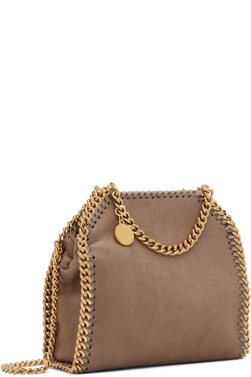 Faux-suede shoulder bag. 

· Whipstitching and chain trim throughout
· Curb chain carry handles and shoulder strap
· Logo disc at strap base
· Magnetic press-stud closure
· Patch pocket at interior
· Logo-patterned textile lining
· Gold-tone hardware
· H7" x W6" x D2.5" 

Made from cruelty-free, non-animal materials.

Supplier color: Moss