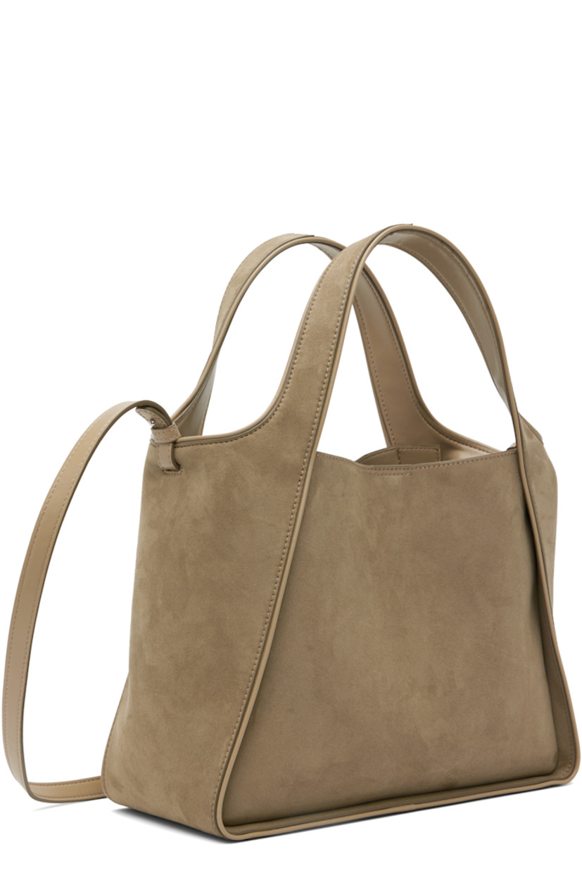Faux-suede tote. 

· Piping throughout
· Integrated carry handles
· Adjustable and detachable crossbody strap
· Perforated logo at face
· Magnetic press-stud closure
· Detachable pouch-on-lanyard at interior
· Buffed faux-leather interior
· H10" x W12" x D5"

Made from cruelty-free, non-animal materials.

Supplier color: Khaki