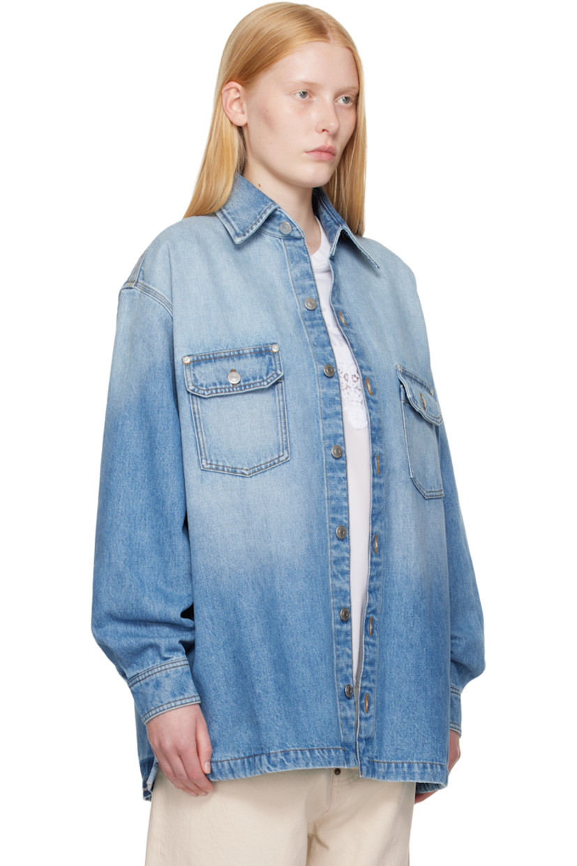 Non-stretch GOTS-certified organic cotton denim shirt. Fading throughout. 

· Spread collar
· Button closure
· Flap pockets at chest
· Shirttail hem
· Vented side seams
· Dropped shoulders
· Pleats at buttoned barrel cuffs
· Box pleat at back yoke
· Logo embroidered at back hem
· Logo-engraved silver-tone hardware
· Contrast stitching in tan

Made from cruelty-free, non-animal materials.

Supplier color: Mid vintage blue