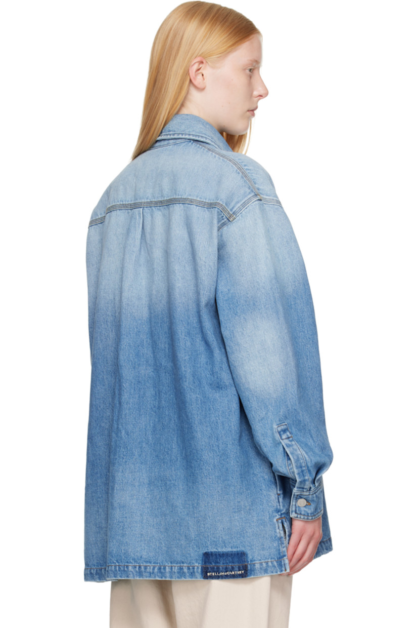 Non-stretch GOTS-certified organic cotton denim shirt. Fading throughout. 

· Spread collar
· Button closure
· Flap pockets at chest
· Shirttail hem
· Vented side seams
· Dropped shoulders
· Pleats at buttoned barrel cuffs
· Box pleat at back yoke
· Logo embroidered at back hem
· Logo-engraved silver-tone hardware
· Contrast stitching in tan

Made from cruelty-free, non-animal materials.

Supplier color: Mid vintage blue