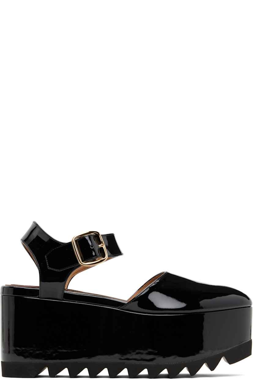 Handcrafted patent faux-leather sandals.

· Cutout at toe
· Pin-buckle ankle strap
· Covered wedge heel and platform midsole
· FSC-certified beech wood heel and midsole
· Treaded rubber sole
· Platform: H2.75"
· Heel: H3.5"

Made from cruelty-free, non-animal materials.

Supplier color: Black