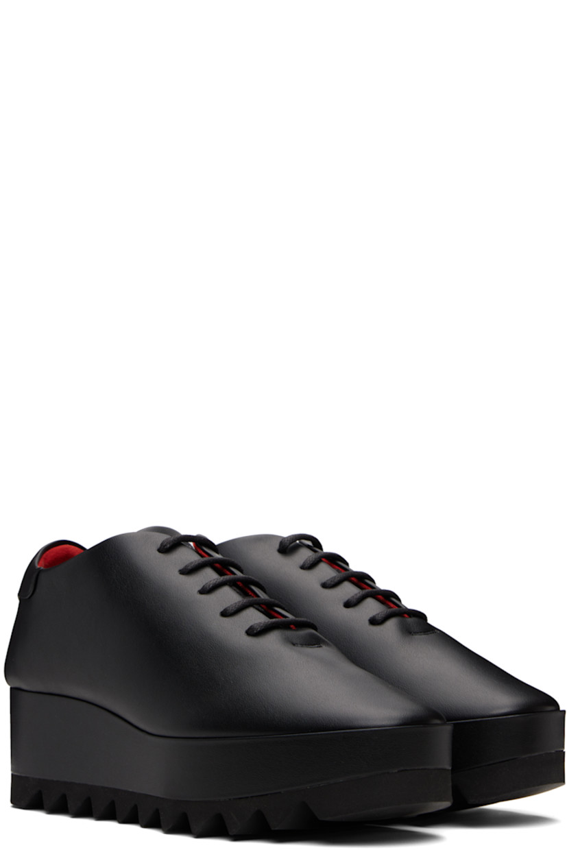 Low-top buffed faux-leather sneakers.

· Lace-up closure
· Logo patch at padded tongue
· Padded collar
· Logo stamp at heel tab
· Mesh lining
· Covered platform midsole
· Treaded foam rubber sole
· Platform: H1.5"
· Heel: H2.25"

Made from cruelty-free, non-animal materials.

Supplier color: Black