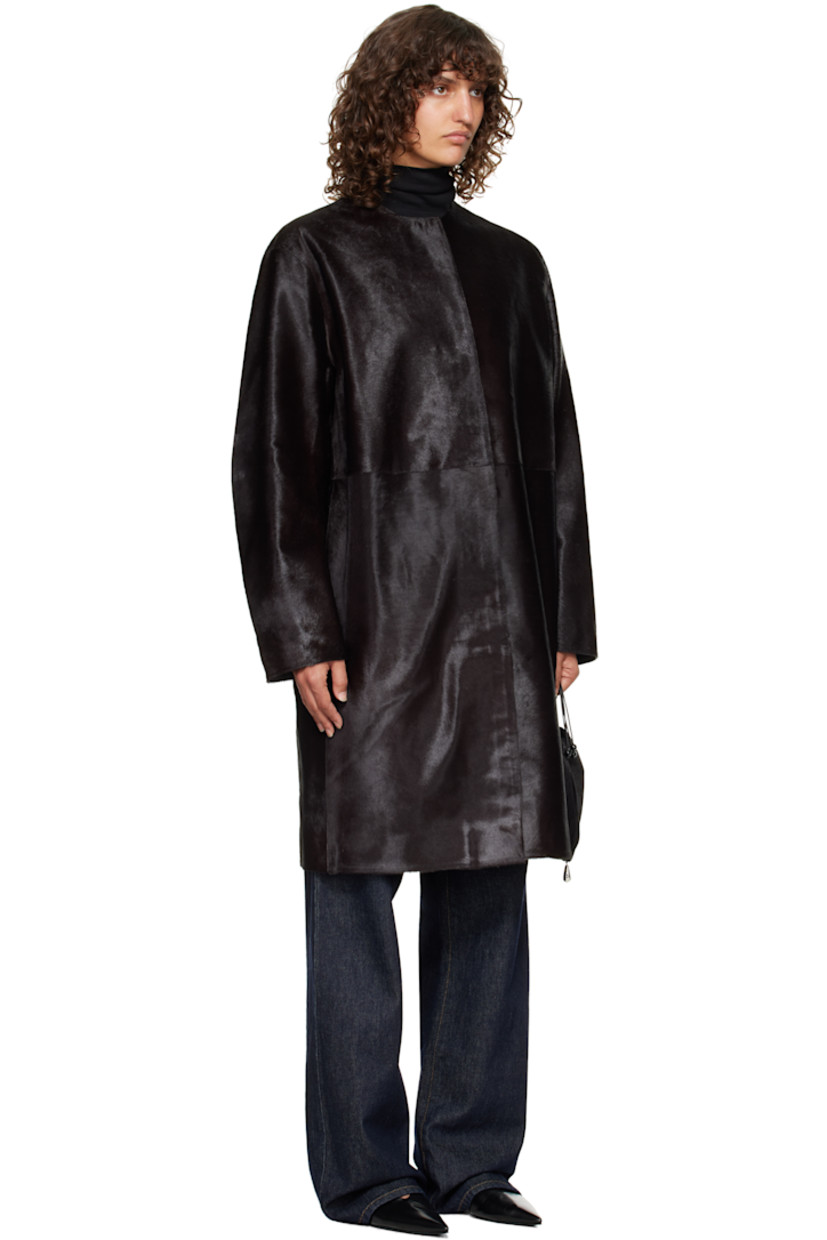 Calf-hair coat.

· Round neck
· Concealed button closure
· Seam pockets at waist
· Welt pocket at interior
· Full satin lining

Supplier color: Coffee
