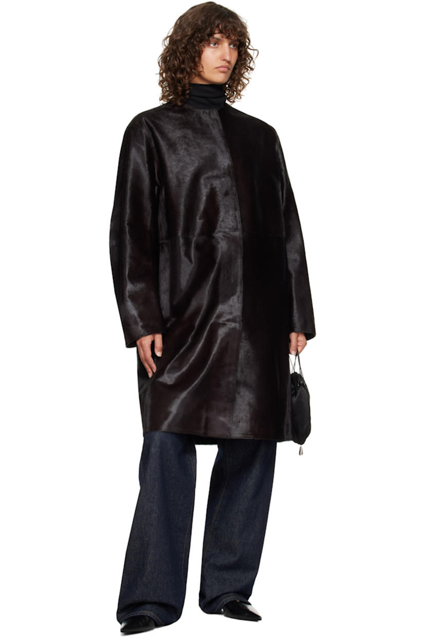 Calf-hair coat.

· Round neck
· Concealed button closure
· Seam pockets at waist
· Welt pocket at interior
· Full satin lining

Supplier color: Coffee