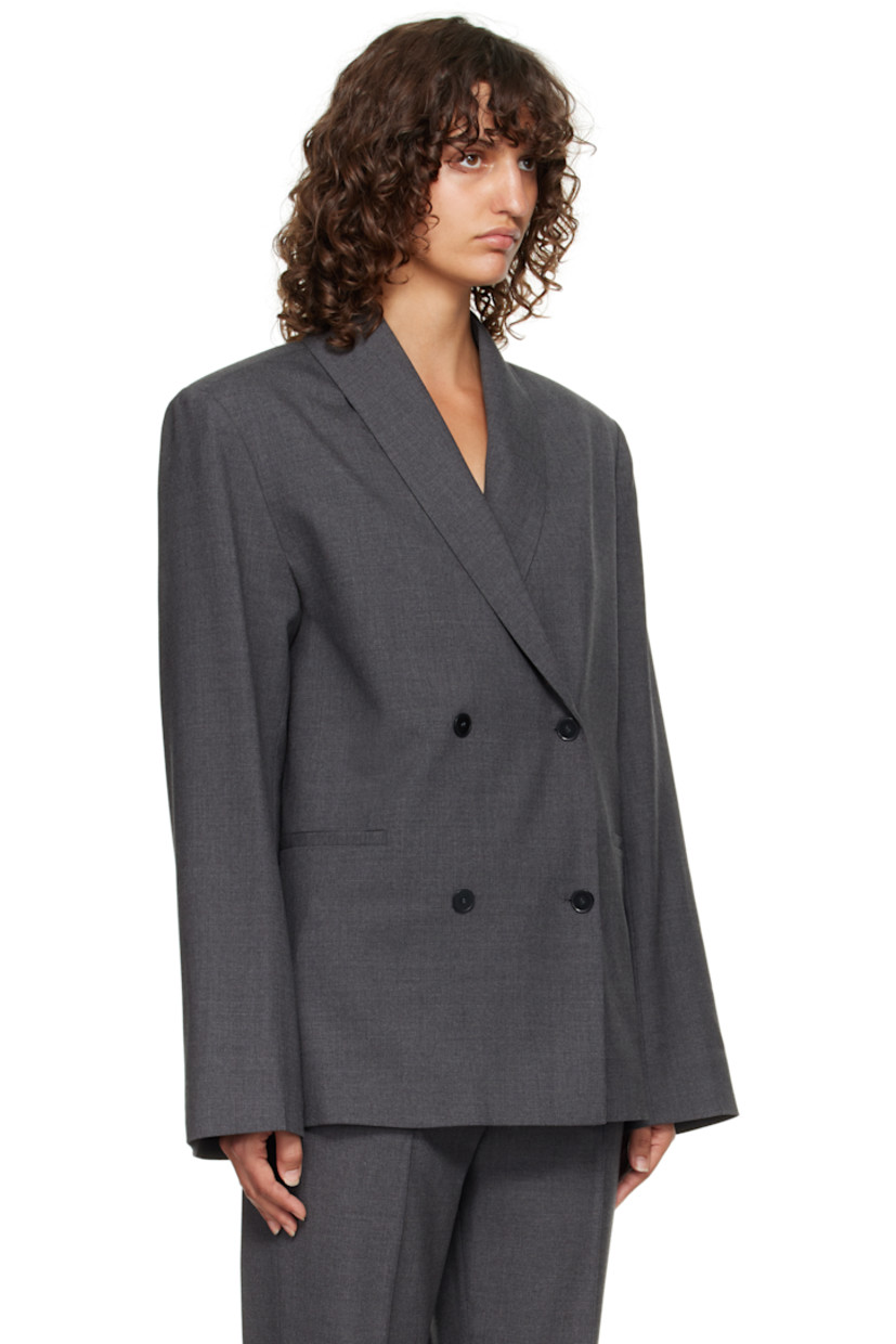 Stretch virgin wool grain de poudre blazer.

· OEKO-TEX® STANDARD 100-certified
· Shawl lapel
· Double-breasted button closure
· Welt pockets at waist
· Padded shoulders
· Welt pocket at interior
· Full satin lining

Supplier color: Anthracite melange